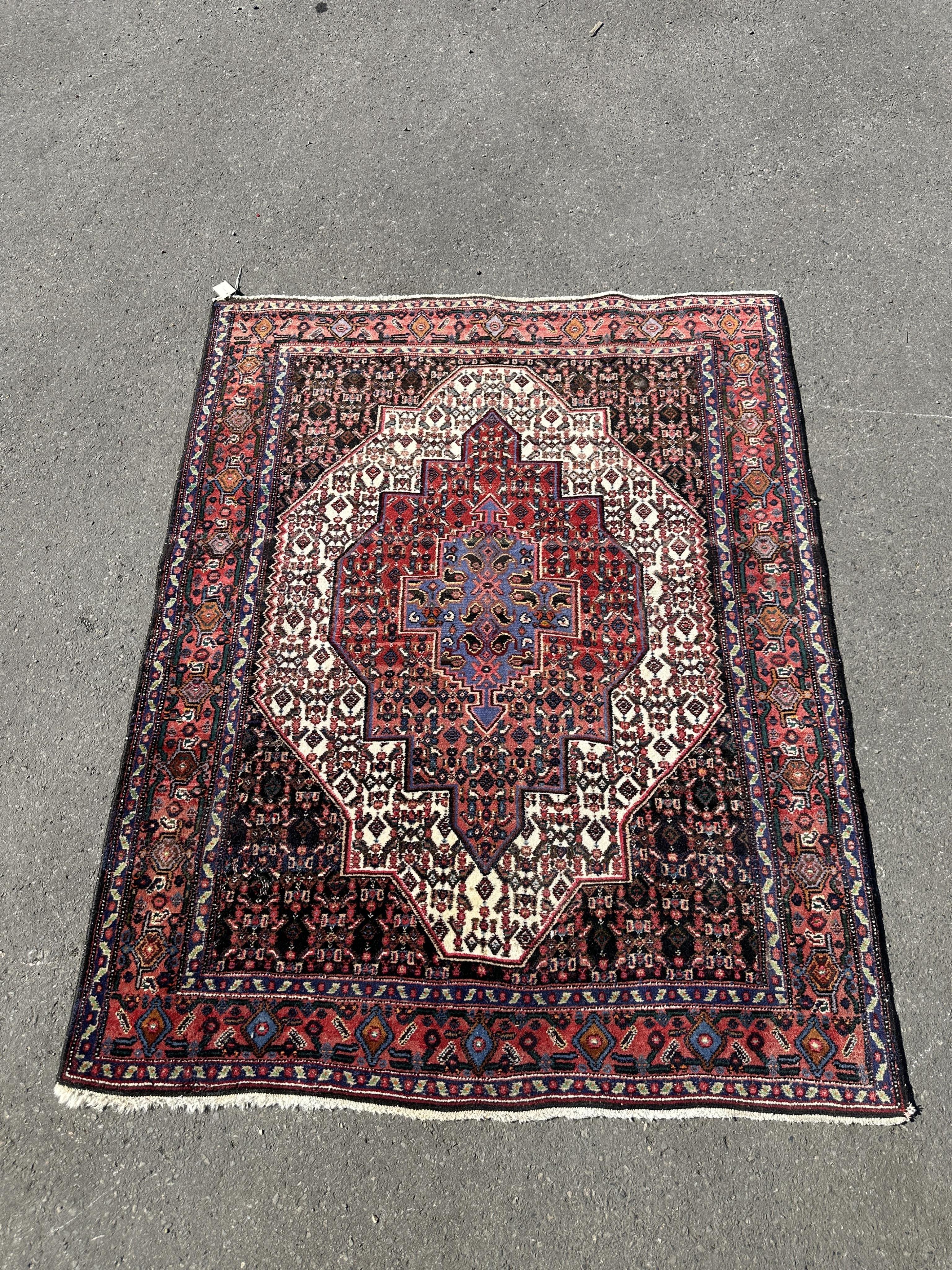 A North West Persian ivory ground rug, 158 x 126cm